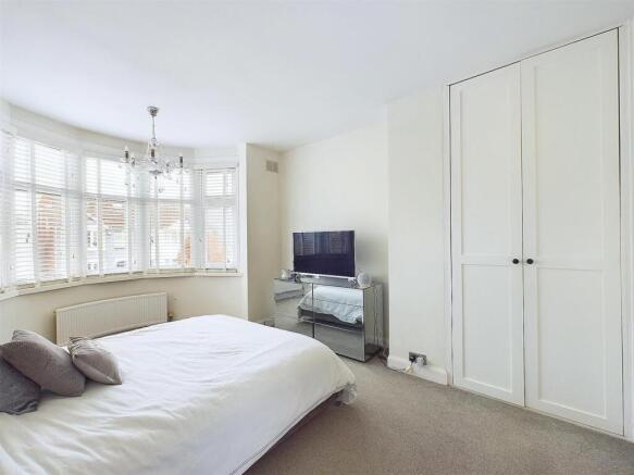 Bright, neatly presented bedroom with a large b...