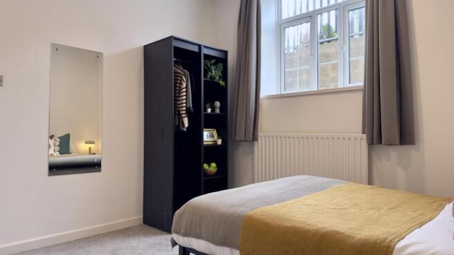 A bright and inviting double bedroom featuring ...