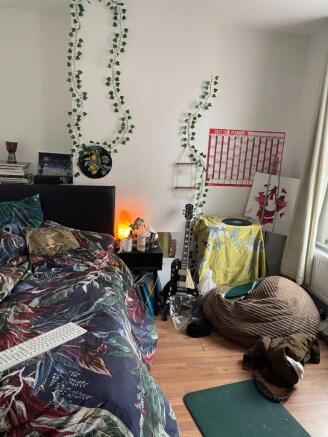 A cozy double bedroom with vibrant decor and a ...