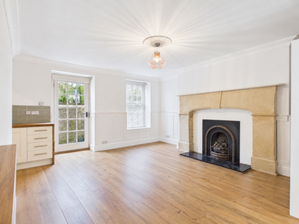 Empty room with fireplace and cabinetry