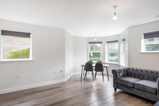 Bright, airy lounge with stylish bay window sea...