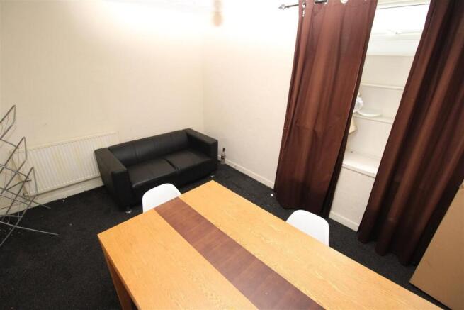 Cosy lounge area with leather sofa and dining t...