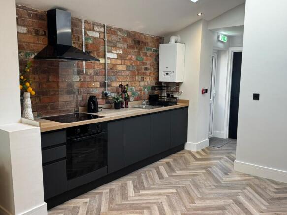 Modern kitchen with exposed brick and chic unit...