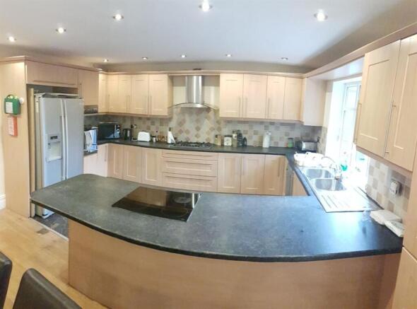 Spacious modern kitchen with wraparound counter...