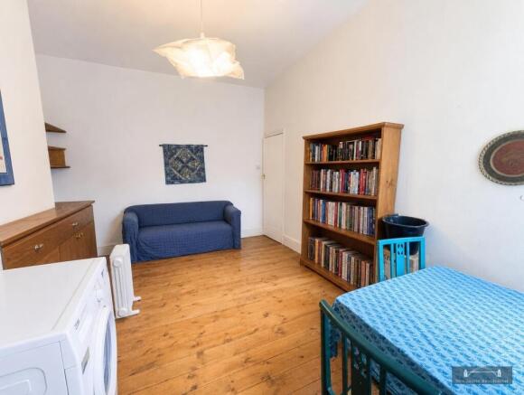 Spacious living area with wooden floor...