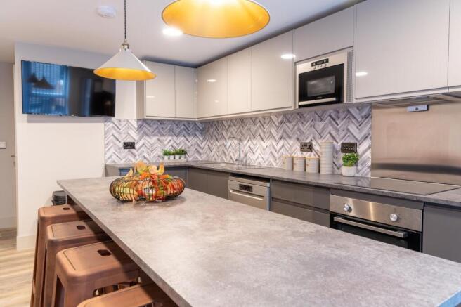 Modern kitchen island with stools and stylish t...