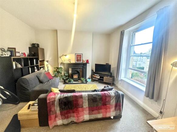 Bright living area with large windows and heart...