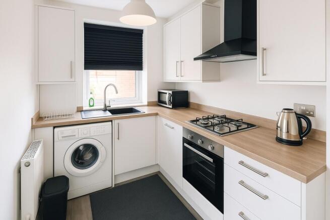 Modern, bright kitchen featuring white cabinets...