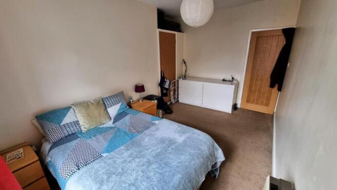 A cozy double bedroom featuring a neatly made b...