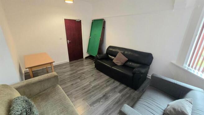 Bright, modern communal lounge with laminate fl...