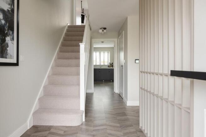 The entrance hall is flooded with natural light and there's space for understairs storage