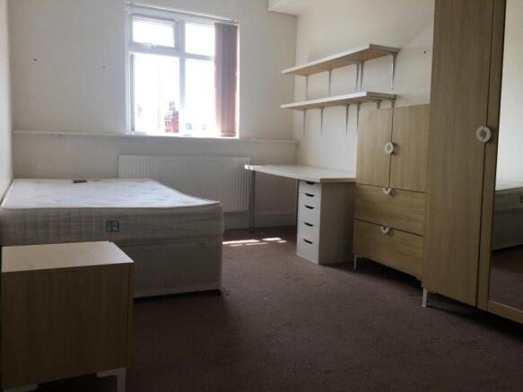 Bright, simply furnished double bedroom with a ...