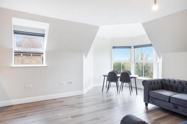Bright open living area with scenic bay window...