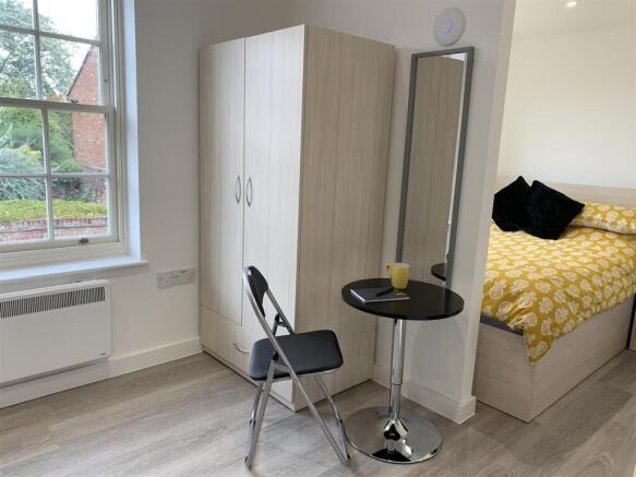 Bright modern bedroom with ample storage space...