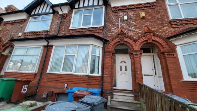 Red-brick terraced house with bay window and ar...