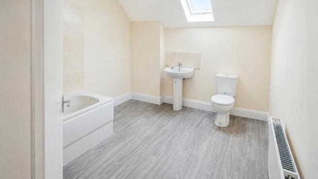 Bright and spacious bathroom with skylight...