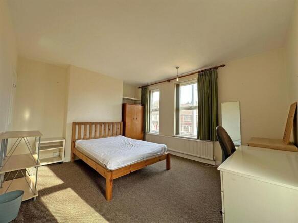 Spacious bedroom with study area and natural li...