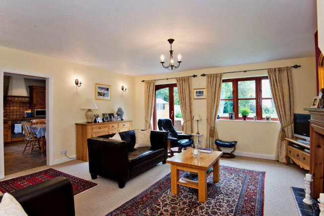 Sitting Room with views to the rear garden and acc