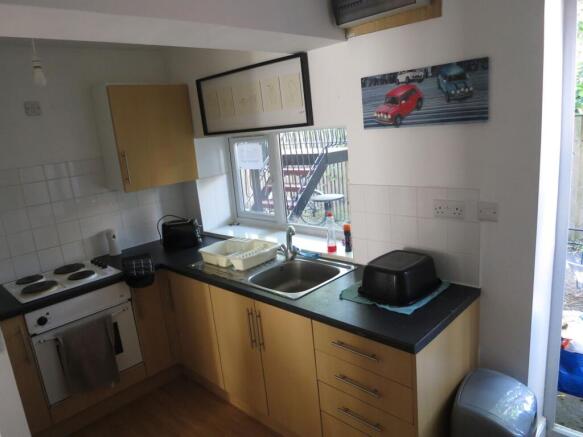 Bright fitted kitchen with wood-effect cabinets...