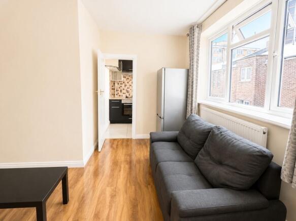 Bright living area with large window and sofa...