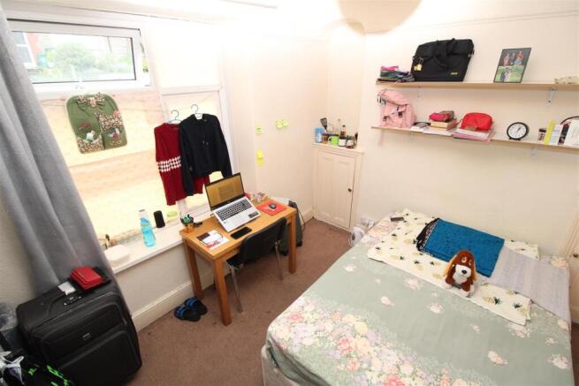 Bright bedroom with double bed and desk area...