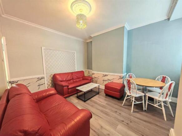Bright lounge with red sofas and dining area...