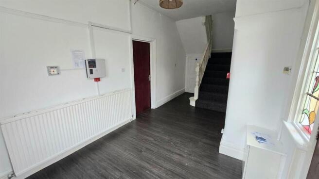 Spacious hallway with modern wood-effect floori...