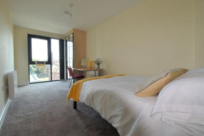 A bright and tidy single bedroom featuring a co...