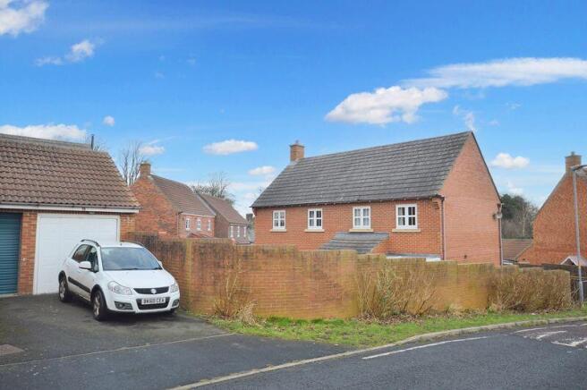 Rear aspect - drive and garage