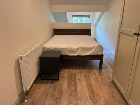 Bright double bedroom with modern wood flooring...