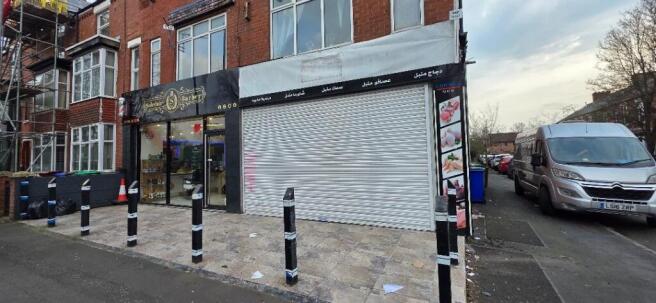 Ground-floor retail frontage with shutter and s...