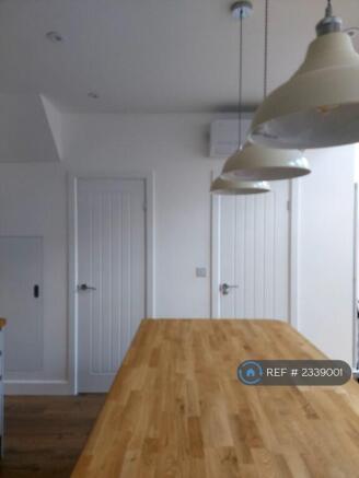Doors To Utilities And Downstairs Bathroom