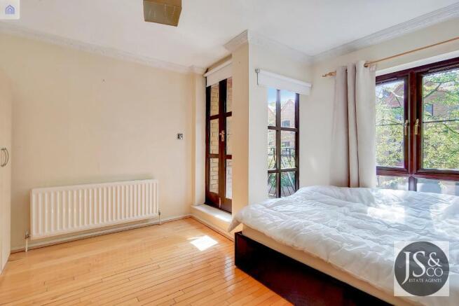 First bedroom with a balcony