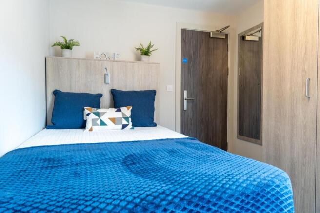 A bright and inviting master bedroom featuring ...