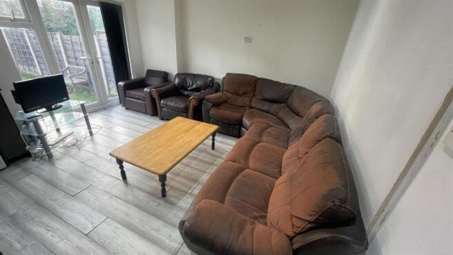 Bright, comfortable living room with a large cu...