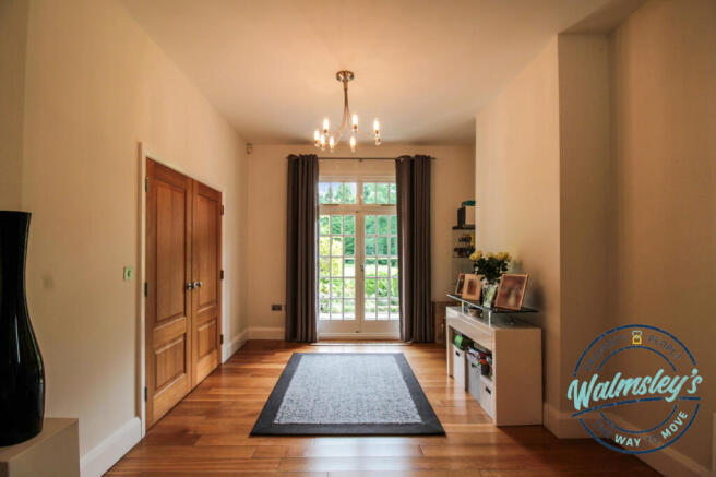 Welcoming entrance hallway with French doors to th