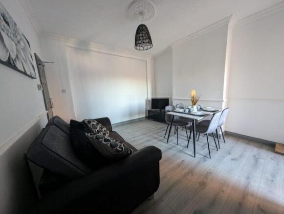 Bright, modern living room with wood-effect flo...