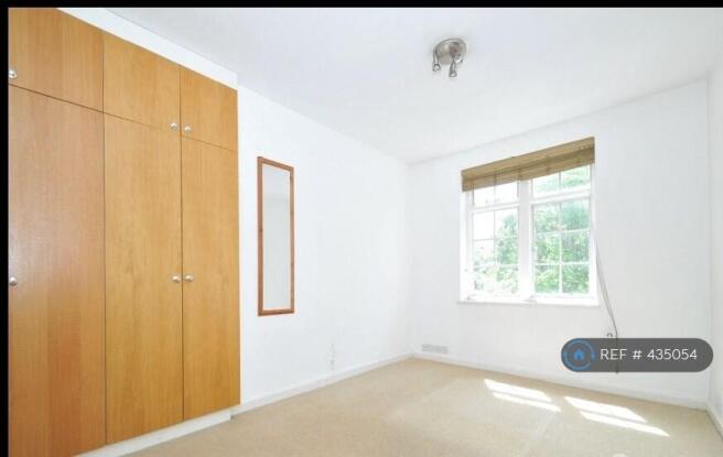 Living Room: Double Bed, Armchair, Table, Chairs