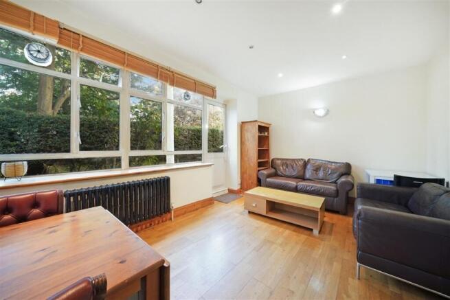 Bright lounge with large windows and wood floor...