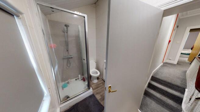 A bright, clean bathroom featuring a shower uni...