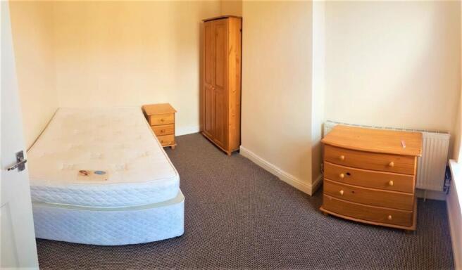 Bright, simply furnished single bedroom with a ...