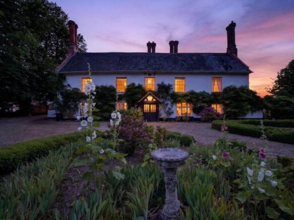 Bury's Hall Ashill manor house facade at sunset wi