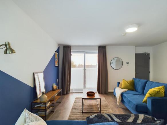 A bright and inviting living room featuring com...