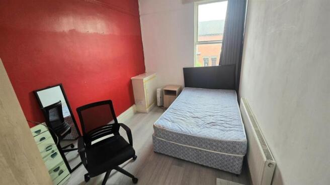 Neat single bedroom with a comfortable bed, sim...