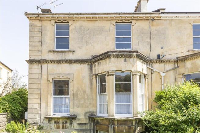Elegant period facade with bright bay windows...