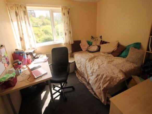 A cozy bedroom featuring a comfortable double b...