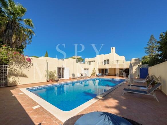 Moorish-style luxury villa for sale in Carvoeiro Clube, Algarve, featuring a large renovated swimming pool, sun terrace, and private garden.