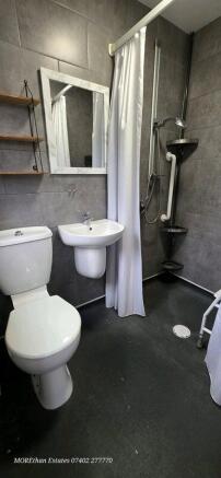 Modern tiled bathroom with shower and sink...