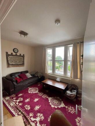 Bright living room with a large front window, c...