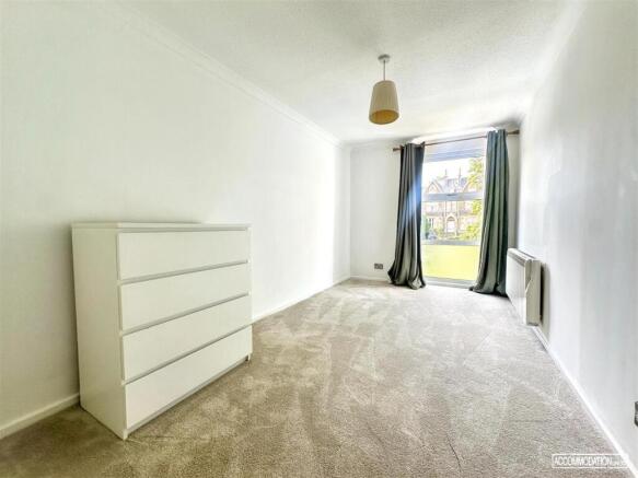 Bright and airy bedroom with modern storage...